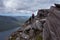 Two walkers travering ridge trail overlooking lake in Scottish H