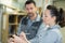 Two warehouse workers smiling and holding tablet