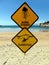 Two warning signs on a beach warning of dangerous marine stingers and bluebottle jelly fis