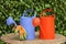 Two watering cans and garden gloves