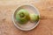 Two watermelon radishes in a white bowl on a rustic wood table