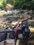 Two waterpumps to pump water for gold mining, the dirt flushes away in the river at the background