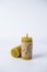 Two wax candles wrapped in kraft paper and tied with twine on a white background. natural beeswax. handmade candles
