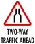 Two-way traffic ahead sign on white background