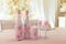 Two wedding champagne bottles and glasses decorated with lace, flowers and Cupid angels figures standing on festive table