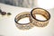 Two wedding rings with rare design on white broad ribbon