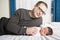 Two week newborn baby with father in bed