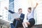 Two western business men and women sit and talk on the outdoor stairs