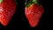 Two wet strawberries collide with each other