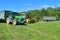 Two-wheeled tractors John Deere trailers with cut grass and forage harvester John Deere