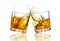 Two whiskey glasses clinking together, isolated