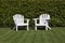 Two white adirondack chairs