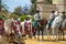 Two white andalusian horses with 3 jockeys to rearRegistrar versiÃ³n: