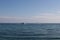 Two white boats navigating towards each other in the sea on a summer day