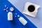 Two white bottle, pills, coffee cup on blue background. Concept Insomnia, full moon time, sleep problems, soporific. Mockup, Top