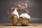 Two white broken vases with orange and white flowers