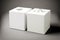 two white cardboard square tissue box on gray background