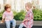 Two white Caucasian cute adorable funny children toddlers sitting together