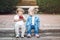 Two white Caucasian cute adorable funny children toddlers sitting together sharing eating apple food