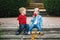 Two white Caucasian cute adorable funny children toddlers sitting together sharing eating apple food