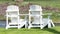 Two white chairs at the waterfront