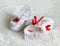 Two White children\'s bootees, shoes with red ribbons