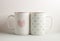 Two white cups with lovely heart prints