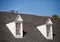 Two White Dormers on Grey Shingle Roof