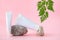 Two white empty tubes and natural stones on a pastel pink background. Cosmetic product branding mockup. spa care concept