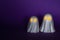 Two White Ghosts Halloween decor with glowing eyes on a purple background