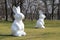 Two white giant Easter bunnies in the park in Poznan, Poland