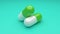 Two white-green pills rotating on green background. Seamless looping.