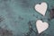 Two white hearts on a blue textured shabby background, empty space for text
