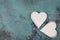 Two white hearts on a blue textured shabby background, empty space for text