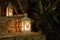 Two white lamps with burning flame on street steps. Lantern in the evening garden in Asia. Romantic decoration.