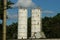 Two white long industrial metal towers at a factory