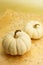 Two white miniature pumpkins