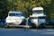 Two white motor boats on trailers