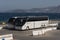 Two white painted tourist coaches parked on the seafront, Crete, Greece