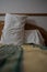 Two white pillows in a hotel resting on a bed ready to support tired back of a person resting