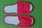 Two white red slippers made of fabric