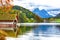 Two white swans in crystal clear water Grundlsee Lake.