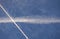 Two white trails from commercial airplanes, another plane flying, white moon near - chemtrails conspiracy theory concept