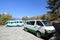 Two white vans at parking space on the hill, Bhutan