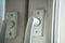 Two white window handles, close