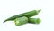 Two whole and one half of green okra. Rotating on the turntable. Isolated on the white background. Close-up