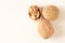 Two whole walnuts and one split walnut on white background with free space