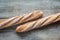 Two wholewheat baguettes on the wooden background