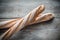 Two wholewheat baguettes on the wooden background