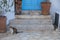 Two wild cats in front of blue door. Folegandros Island, Greece